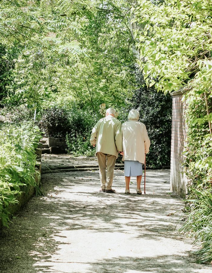 Elderly couple walking together — arriving at the shore