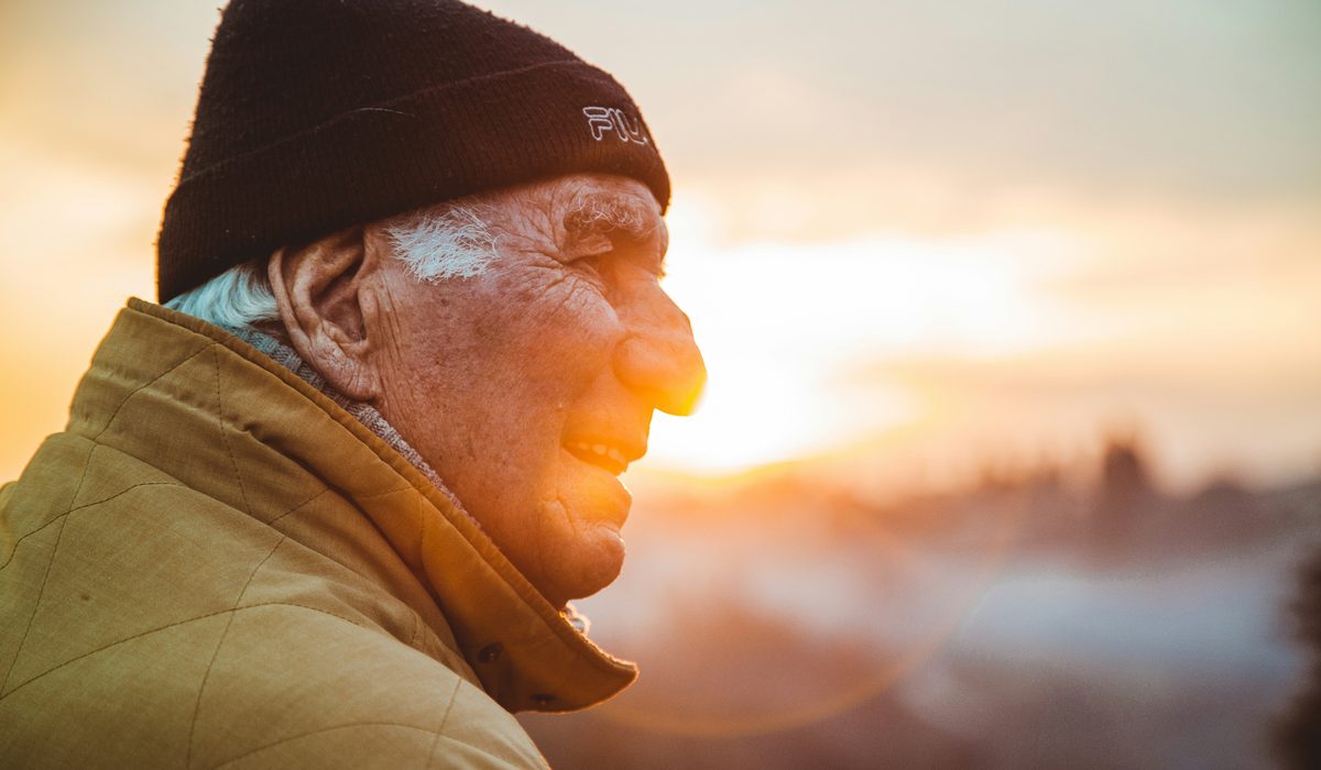 Elderly man at sunset by the shore